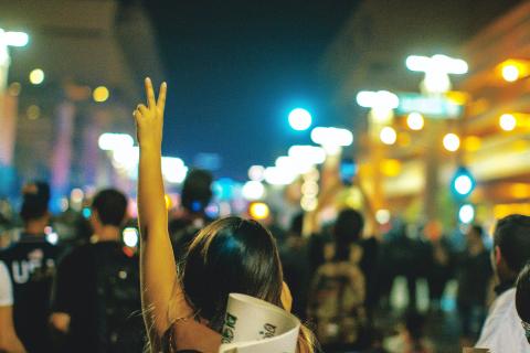 An activist raising a peace/victory sign