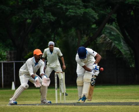 A batsman playing a defensive shot