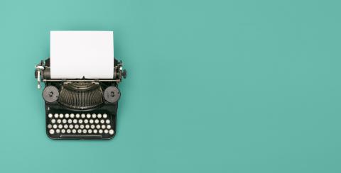 Old style typewriter on a teal background