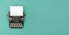 Old style typewriter on a teal background