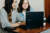 Two students looking at a laptop